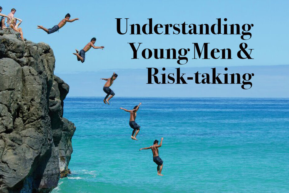 Young men jumping off a cliff into the ocean