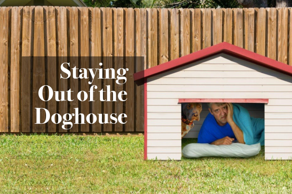 A man and a dog are sharing the doghouse