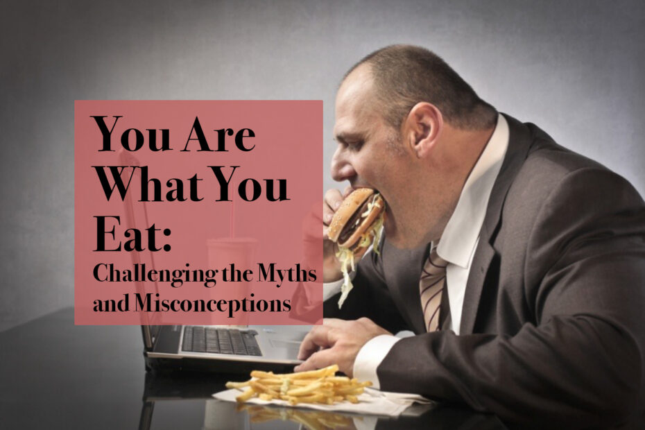 A man is sitting at his desk eating